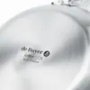 Close-up of the bottom of a metal pan, showing brand markings and symbols. Podgląd zdjęcia produktu