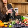 A woman in a kitchen is assembling a food processor with various fruits and vegetables laid out on the counter. Náhľad obrázku produktu