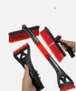 A collection of car snow brushes and ice scrapers with red bristles and black handles, some held by hands. Anteprima dell’immagine prodotto