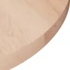 Close-up view of the edge of a round, unfinished solid oak wood tabletop. Anteprima dell’immagine prodotto