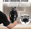 A person is installing a garbage disposal unit under a kitchen sink. Podgląd zdjęcia produktu