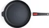 A top-down view of a black frying pan with a black handle and a red accent on a white background. Produktbild-Vorschau