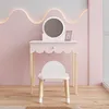 A child's vanity table and stool set in a pink room. Produktbild-Vorschau