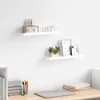 Two white floating shelves mounted on a white wall above a wooden desk. Anteprima dell’immagine prodotto