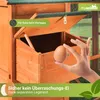 A hand is shown holding an egg next to a wooden chicken coop with an open nesting box. Produktbild-Vorschau