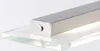 A close-up shot of a silver metallic light fixture mounted on a clear glass shelf. Produktbild-Vorschau