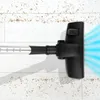 A vacuum cleaner head is shown on a white wooden floor with dirt particles. Produktbild-Vorschau