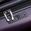 A close-up shot of a luggage lock and zipper on a purple suitcase. Produktbild-Vorschau