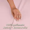 A hand is shown touching a pink fabric, with text overlayed. Produktbild-Vorschau