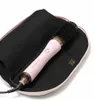 A pink hair dryer brush is placed inside a black heat-resistant pouch. Produktbild-Vorschau