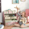 A young girl is playing with toys in a child's room, sitting in front of a toy shelf. Náhľad obrázku produktu