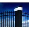 A solar-powered fence post light illuminates a black metal fence against a night sky. Produktbild-Vorschau