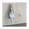 A handheld vacuum cleaner is mounted on a tiled wall and plugged into a charger. Anteprima dell’immagine prodotto