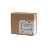 A cardboard box with a decorative label. Produktbild-Vorschau