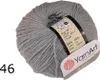 A ball of grey yarn with a label attached. Produktbild-Vorschau