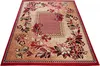 A close-up, angled view of a rectangular rug with a floral pattern. Náhled obrázku produktu
