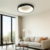 A modern living room with a sofa, coffee table, armchair, and a large window. Produktbild-Vorschau