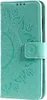 A teal-colored phone case with a mandala pattern embossed on it. Produktbild-Vorschau