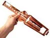 A hand holding a copper fire tong. Produktbild-Vorschau