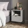 A bedside table next to a bed. Voir les images du produit