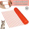 A roll of orange plastic netting is shown, with a close-up of hands stretching a piece of the netting in the upper left corner. A husky dog is also visible in the lower left corner. Náhled obrázku produktu