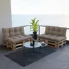 A balcony with a view of the ocean, furnished with pallet furniture and a coffee table. Voir les images du produit