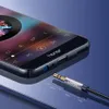 A close-up shot of a smartphone with a music player interface displayed, and a 3.5mm audio cable plug is shown connecting to the phone's audio jack. Produktbild-Vorschau