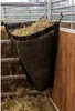 A hay bag filled with hay, hanging in a stable. Anteprima dell’immagine prodotto