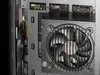 Close-up view of the interior of a computer case, showing a fan and some internal components. Produktbild-Vorschau