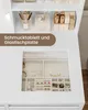 A white vanity table with a glass top revealing a jewelry organizer filled with various accessories. The upper shelf displays makeup brushes, a decorative box, and lipstick tubes. Voir les images du produit