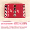 A red jig for drilling holes at angles, placed on a wooden surface. Produktbild-Vorschau