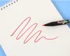 A marker is drawing a red zig-zag line on a white paper. The marker has colorful text on its barrel. Náhľad obrázku produktu