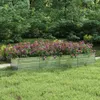A raised garden bed filled with colorful flowers sits on a grassy lawn, with trees in the background. Produktbild-Vorschau