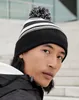 A close-up shot of a person wearing a striped beanie. Náhled obrázku produktu