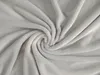 A close-up, swirled view of a light gray microfiber blanket. Produktbild-Vorschau