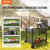 A multifunctional barbecue station is shown outdoors on a grassy lawn, with inset images demonstrating its various uses. Produktbild-Vorschau