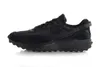 A black Nike Waffle Debut sneaker shown from the side against a white background. Náhled obrázku produktu
