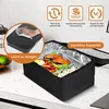 A black lunchbox with food inside, placed on a kitchen counter. Produktbild-Vorschau