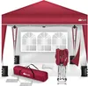 A red pop-up gazebo with its accessories laid out in front of it, including a carrying bag, weights, and stakes. A decorative window panel is shown behind the gazebo. Anteprima dell’immagine prodotto