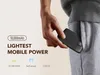 A hand is placing a black power bank into the pocket of grey sweatpants. Produktbild-Vorschau