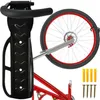 A black bicycle wall mount holding a bicycle wheel and part of the frame. Mounting hardware (screws and wall plugs) are shown to the right. Náhľad obrázku produktu