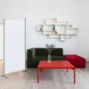 A living room scene with a sofa, coffee table, and a display shelf. Podgląd zdjęcia produktu