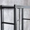 Close-up of a metal firewood rack against a patterned wallpaper. Podgląd zdjęcia produktu