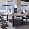 A modern office interior with a long wooden desk and chairs. Produktbild-Vorschau