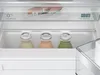 Close-up view of the interior of a refrigerator, showing food items on shelves. Podgląd zdjęcia produktu