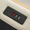 A close-up view of a black charging panel with USB and Type-C ports integrated into a beige fabric surface. Produktbild-Vorschau
