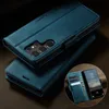A teal leather flip case for a Samsung Galaxy S25 Ultra phone is shown, with the phone inserted and displaying a lock screen. The case is open, revealing card slots and a magnetic closure. The background is a dark, textured surface. Produktbild-Vorschau