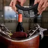 Hands holding a flexible silicone ice cube mold over a bottle of wine in a decorative wooden and metal wine cooler with deer antlers. Náhled obrázku produktu