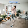 A man is vacuuming a living room with a cordless vacuum cleaner. Produktbild-Vorschau