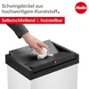 A hand is shown cleaning the lid of a white trash can with a black lid. Anteprima dell’immagine prodotto